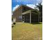 This backyard has a screened-in porch and a large, green lawn at 2044 Sweet William Dr, Harrisburg, NC 28075
