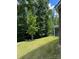 The property features a sloping lawn with lush trees and shrubbery at 2044 Sweet William Dr, Harrisburg, NC 28075