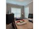 This bedroom features a bed with patterned comforter and two bright windows at 2044 Sweet William Dr, Harrisburg, NC 28075