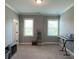 Cozy bedroom with a light gray walls, bright windows, and an entertainment area at 2044 Sweet William Dr, Harrisburg, NC 28075