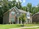 A beautiful two-story brick home with well-maintained landscaping and a lush, green lawn in a suburban setting at 2044 Sweet William Dr, Harrisburg, NC 28075