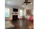 Cozy living room with a fireplace, dark wood floors, bright windows, and an open concept layout at 2044 Sweet William Dr, Harrisburg, NC 28075