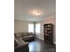 This living room has a gray, leather L-shaped sofa and dark, wood flooring at 2044 Sweet William Dr, Harrisburg, NC 28075