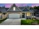 Charming home exterior showcasing a stone facade, attached garage, and well-manicured lawn at 833 B Wynnshire Dr # 55, Hickory, NC 28601