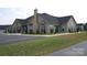 Well maintained exterior of a brick clubhouse with ample parking, a chimney and a grassy lawn at 833 A Wynnshire Dr # 56, Hickory, NC 28601