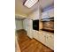 Kitchen with white cabinets, black appliances, and tile backsplash at 1323 Queens Rd # 212, Charlotte, NC 28207