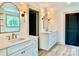 Bathroom featuring double vanities with marble countertops, matching arched mirrors, and sconce lighting at 416 Plantation Way, Mount Gilead, NC 27306