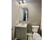 Modern bathroom with square mirror, toilet and sink with gray color scheme at 416 Plantation Way, Mount Gilead, NC 27306