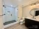 Modern bathroom features a spacious tiled shower with a glass door, sleek vanity, and stylish fixtures at 416 Plantation Way, Mount Gilead, NC 27306