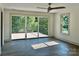 Bright bedroom featuring a walk-out balcony, ceiling fan, large windows and wood-look flooring at 416 Plantation Way, Mount Gilead, NC 27306