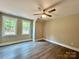 Bright bedroom with two windows and neutral walls, showcasing new floors and a ceiling fan at 416 Plantation Way, Mount Gilead, NC 27306