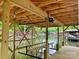 A close-up view of a new wooden boat dock with a lift system on a serene lake at 416 Plantation Way, Mount Gilead, NC 27306