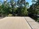 Spacious deck with black railings, offering an outdoor living space with scenic wooded views at 416 Plantation Way, Mount Gilead, NC 27306