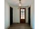 Inviting entryway featuring dark-stained wood floors, black interior doors and modern light fixture at 416 Plantation Way, Mount Gilead, NC 27306