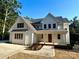Charming two-story home boasts a modern farmhouse exterior with a welcoming front porch and landscaped yard at 416 Plantation Way, Mount Gilead, NC 27306