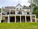 New construction home featuring a walkout basement, a multi-level deck, and a well-manicured lawn at 416 Plantation Way, Mount Gilead, NC 27306