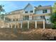 Stunning back exterior of home with a multi-story deck and black railing, perfect for outdoor enjoyment at 416 Plantation Way, Mount Gilead, NC 27306
