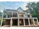 Back exterior view of a home with decks, columns, and a brick foundation at 416 Plantation Way, Mount Gilead, NC 27306