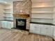 Living room brick fireplace with built-in white cabinets and shelving on both sides at 416 Plantation Way, Mount Gilead, NC 27306