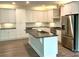Bright kitchen showcasing white cabinetry, stainless steel appliances, and a kitchen island at 416 Plantation Way, Mount Gilead, NC 27306