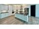 Modern kitchen with white cabinets, stainless steel appliances, and island with seating at 416 Plantation Way, Mount Gilead, NC 27306