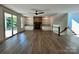 Spacious living room with fireplace, built-in shelving, and access to the outdoor balcony at 416 Plantation Way, Mount Gilead, NC 27306