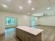 Open-concept living room features an island, recessed lighting, and outdoor access at 416 Plantation Way, Mount Gilead, NC 27306