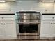 Close up view of the stainless steel ZLINE oven surrounded by white cabinets at 416 Plantation Way, Mount Gilead, NC 27306