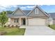 Charming home featuring a stone facade, an attached two-car garage, and a well-manicured lawn at 831 B Wynnshire Dr # 60, Hickory, NC 28601