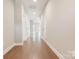 Bright hallway with wood flooring leads to living spaces, showcasing the home's layout at 831 B Wynnshire Dr # 60, Hickory, NC 28601