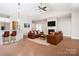 Open-concept living room with a fireplace, hardwood floors and bar seating at the kitchen counter at 831 B Wynnshire Dr # 60, Hickory, NC 28601