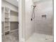 Modern shower with tiled walls and rainfall showerhead next to a walk-in closet at 831 B Wynnshire Dr # 60, Hickory, NC 28601