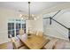 Dining room boasts a modern chandelier, large windows and leads into a staircase at 2907 Meherrin Ct, Waxhaw, NC 28173