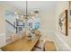 View of dining room showcasing modern chandelier and open concept view of living room and stairs at 2907 Meherrin Ct, Waxhaw, NC 28173