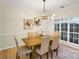 Bright dining room featuring a modern chandelier, light wood floors, and a large window at 2907 Meherrin Ct, Waxhaw, NC 28173