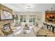 Bright living room with stone fireplace open to the kitchen with barstool seating at the counter at 2907 Meherrin Ct, Waxhaw, NC 28173