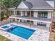 Aerial view of luxury home with pool, hot tub, and landscaped backyard at 110 Emmaline Ct, Troutman, NC 28166