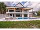 A two-story home with a spacious patio, swimming pool, and lush greenery at 110 Emmaline Ct, Troutman, NC 28166