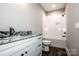 Bathroom features a tub with marble tile and a black granite vanity top at 110 Emmaline Ct, Troutman, NC 28166