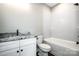 Well-lit bathroom featuring a granite countertop vanity and shower-tub combo at 110 Emmaline Ct, Troutman, NC 28166