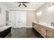 Primary bath with double vanities, walk-in shower, soaking tub, and tile floors at 110 Emmaline Ct, Troutman, NC 28166