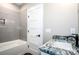 This bathroom features a tub with gray subway tile and a granite vanity top at 110 Emmaline Ct, Troutman, NC 28166