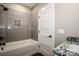 This bathroom features a tub with gray subway tile and a granite vanity top at 110 Emmaline Ct, Troutman, NC 28166