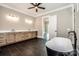 Primary bathroom featuring double vanities, walk-in shower, soaking tub, and modern fixtures at 110 Emmaline Ct, Troutman, NC 28166