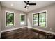 Bright and airy bedroom with hardwood floors, complemented by black-trimmed windows at 110 Emmaline Ct, Troutman, NC 28166