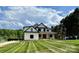 Beautiful modern farmhouse with manicured lawn, complemented by a picturesque sky and lush greenery at 110 Emmaline Ct, Troutman, NC 28166