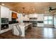 A kitchen features an island with a marble countertop, stainless appliances, and custom white cabinets at 110 Emmaline Ct, Troutman, NC 28166