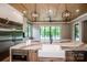 Kitchen with a marble countertop island, stainless appliances, hardwood floors, and natural light at 110 Emmaline Ct, Troutman, NC 28166