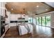 An open-concept kitchen with a quartz countertop island, stainless appliances, and hardwood floors at 110 Emmaline Ct, Troutman, NC 28166