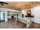 An open kitchen with stainless steel appliances, a marble island, and hardwood floors at 110 Emmaline Ct, Troutman, NC 28166